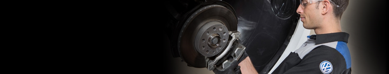 man inspecting brakes